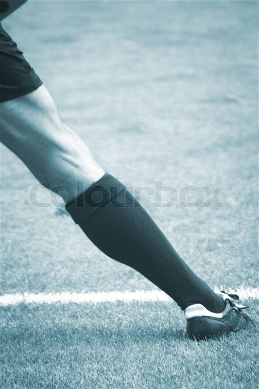 Soccer football pitch white line and linesman referee black and white photo in blue tones, stock photo