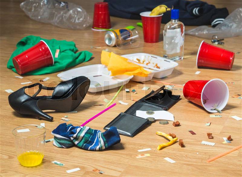 Next morning to a party. Horrible mess and chaos after crazy night at partying and drinking. Trash, bottles, food, cups and clothes on the floor. Messy hangover or drinker\'s remorse concept, stock photo