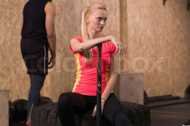 Sport Fitness People Group Crossfit Training Equipment, Serious Young Healthy Woman Sit On Tire Gym Interior, stock photo