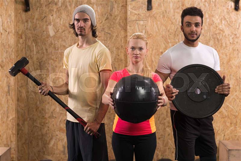 Sport Fitness People Group Crossfit Training Equipment, Young Healthy Man And Woman Gym Interior Doing Exercises, stock photo
