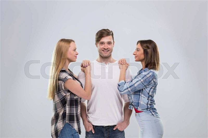 Casual People Group, Young Man Two Woman Happy Smile Handsome Guy Beautiful Girls Over Grey Background, stock photo