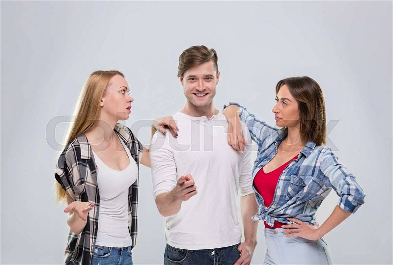 Casual People Group, Young Man Two Woman Happy Smile Handsome Guy Beautiful Girls Point Finger To You Talking Over Grey Background, stock photo