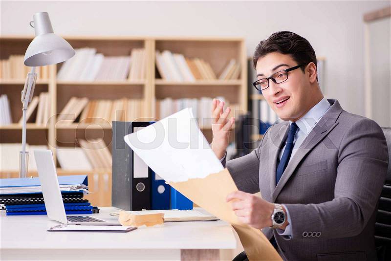 Businessman receiving letter in the office, stock photo