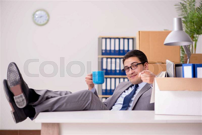 Young handsome businessman moving offices, stock photo