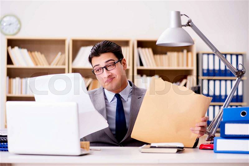 Businessman receiving letter envelope in office, stock photo