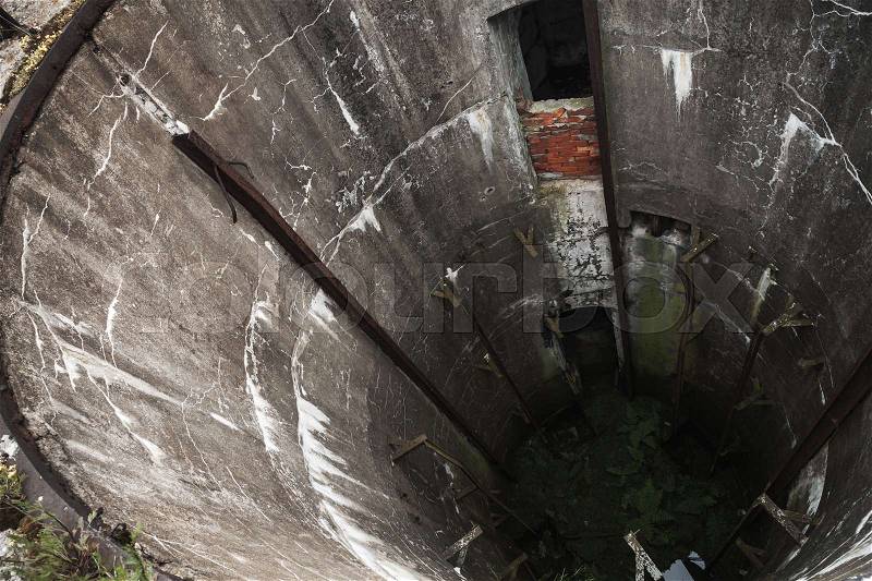 Abandoned military silo. Grunge concrete well interior, stock photo