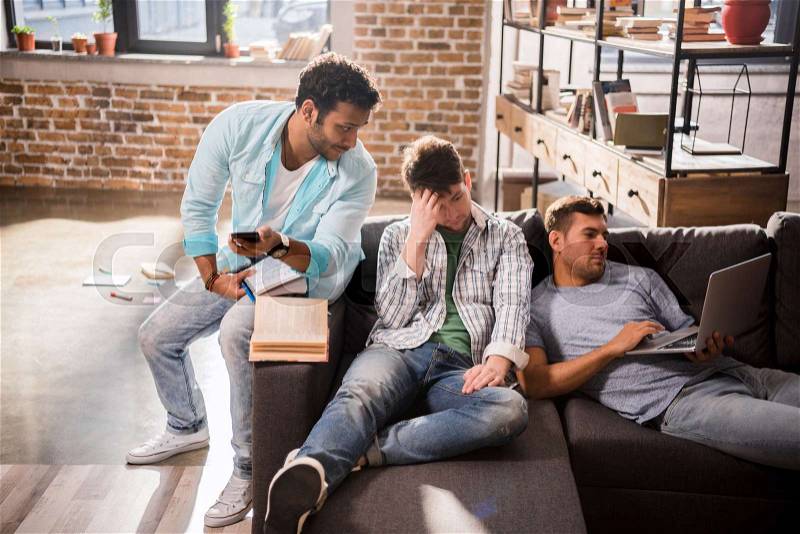 Pensive young professionals working on new business project in small business office , stock photo