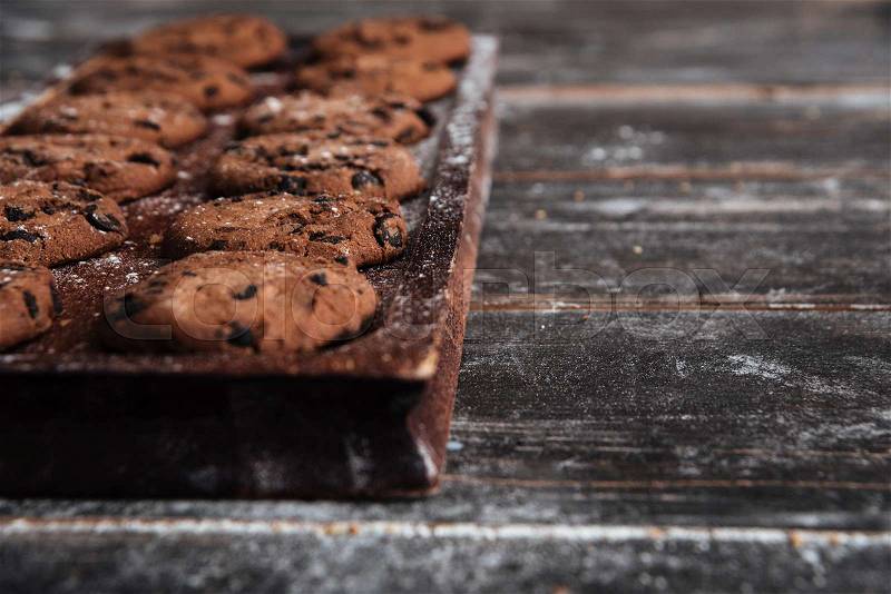 Image of cookies on desk on dark wooden table at bakery, stock photo
