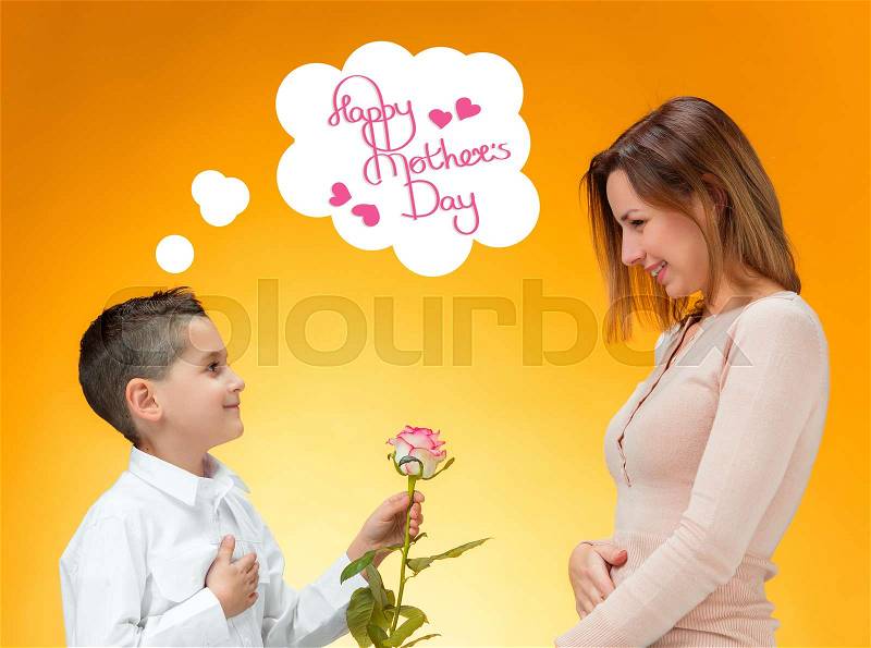 Young kid giving red rose to his mom. Happy mothers day concept, stock photo