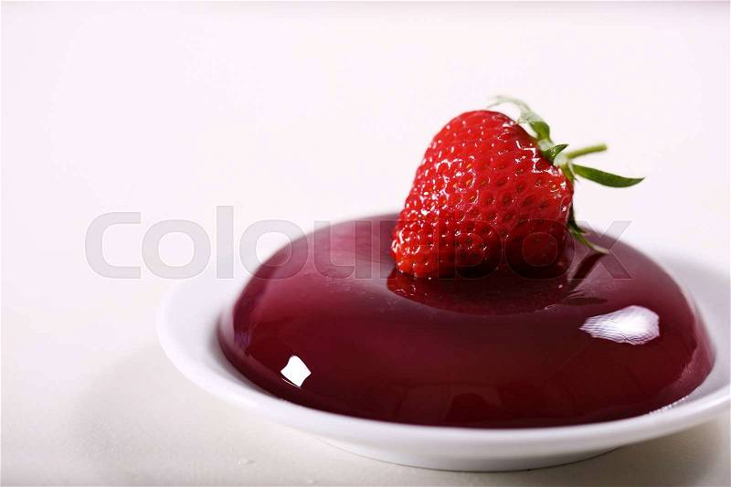 Strawberry jelly decorated with fresh strawberries, stock photo