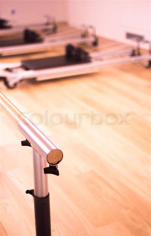 Pilates exercise training and flexibility stretching bar equipment in gym yoga and wellbeing studio, stock photo