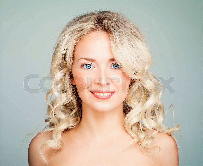 Smiling Model Woman with Blonde Curly Hair. Friendly Face, stock photo