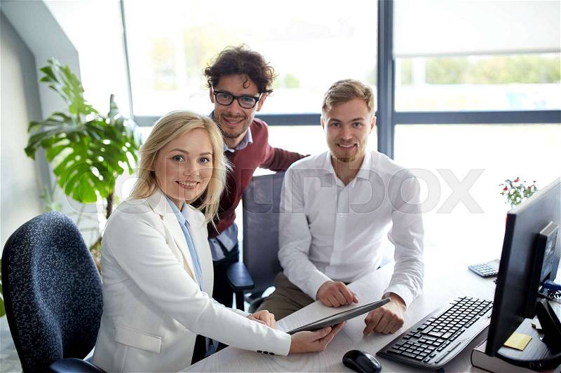 Business, technology, break and people concept - happy creative team with tablet pc computer at office, stock photo