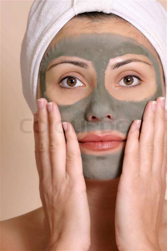 Beautiful girl wearing a purifying beauty mask on her face, stock photo