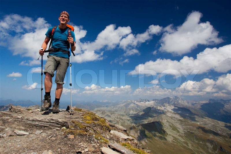 Young hiker enjoying mountain trekking, stock photo