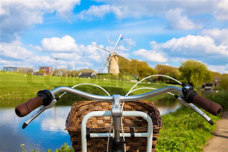 Bicycle and windmill. Symbols of the Netherlands. Tourism, bicycle tour, travel concept, stock photo