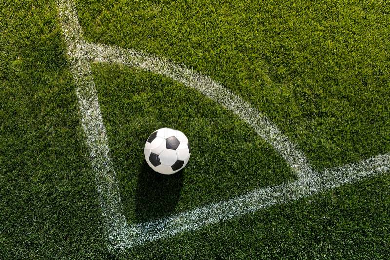 Soccer ball on grass in corner kick position on soccer field stadium, stock photo