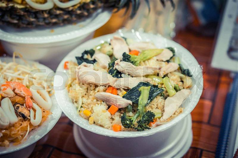 Rice with chicken, seafood and vegetables. Night food market, Thailand, stock photo