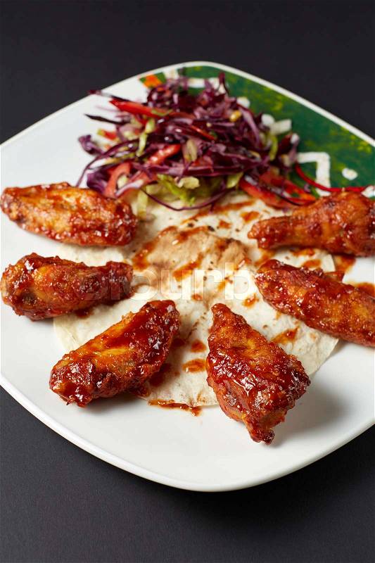 Chicken wings in Mexican style. Mexican food. Mexican cuisine. Studio shot on dark or black background. , stock photo