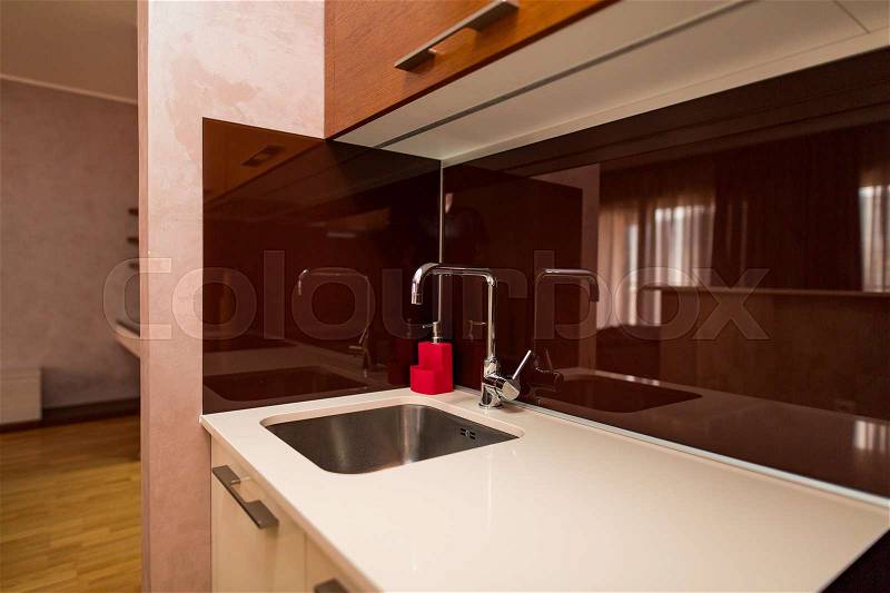 Kitchen sink. Tap water in the kitchen. The interior of the kitchen room of the apartment, stock photo