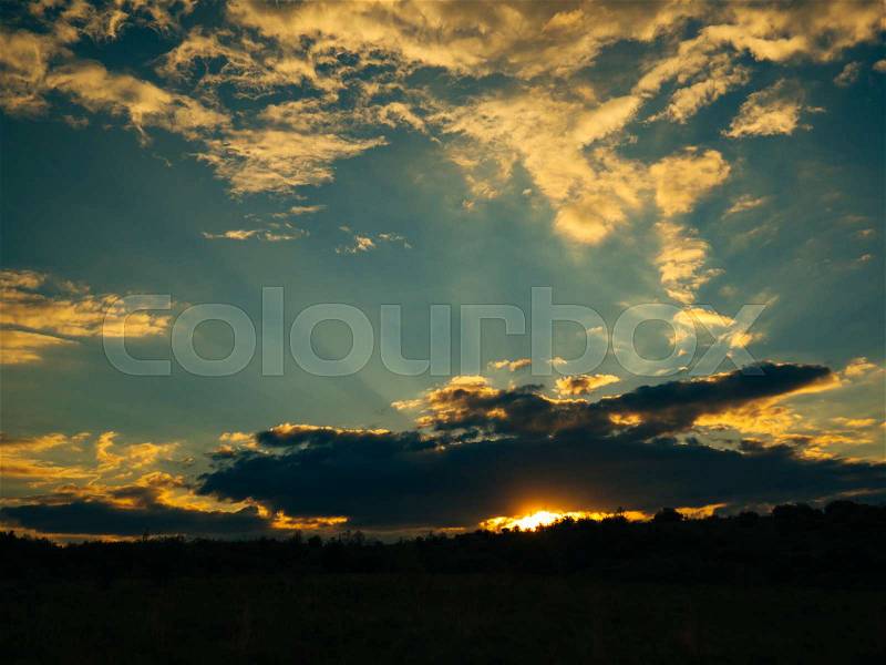 Sunset in the sky. Sunset sky in the clouds and the red sun, stock photo