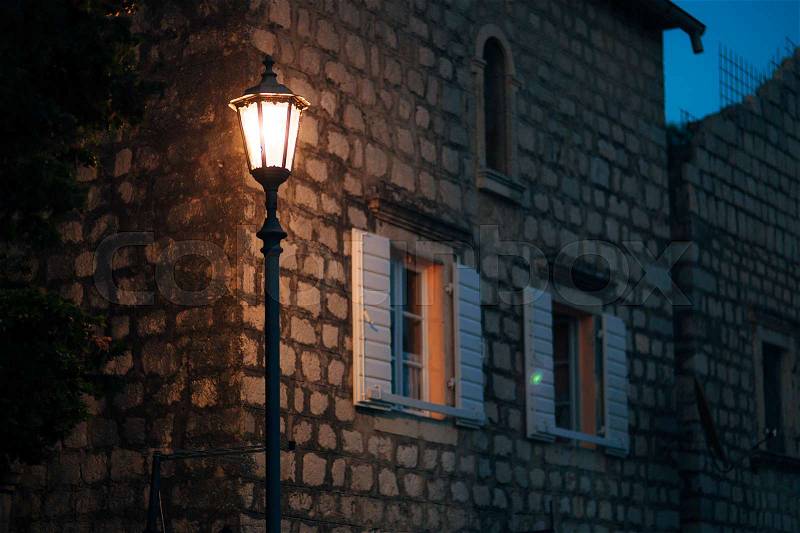 Vintage lamp on the wall on the street, stock photo