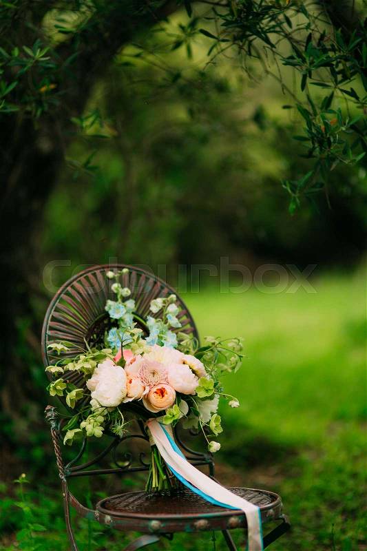 Wedding bouquet of peonies on a vintage metal chair Wedding in Montenegro, stock photo