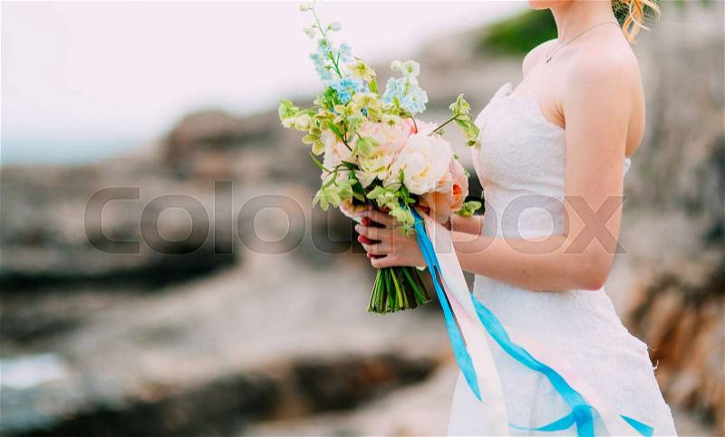 Wedding bouquet of peonies in the hands of the bride. Wedding in Montenegro, stock photo