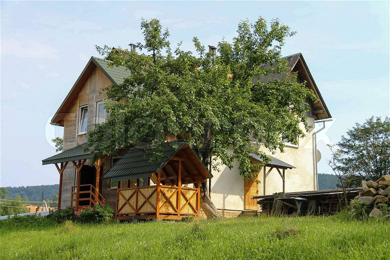 Modern cottage with wooden porch and veranda. Carpathians, Ukraine, stock photo