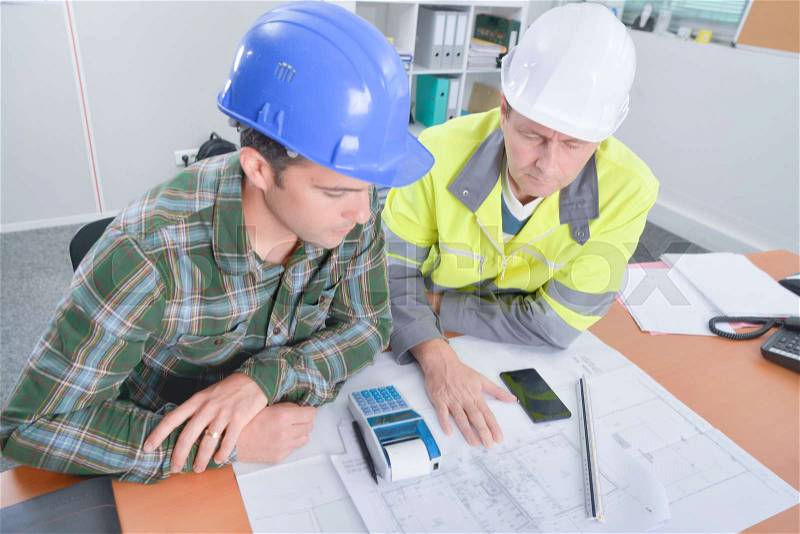 Architects looking at the costs, stock photo