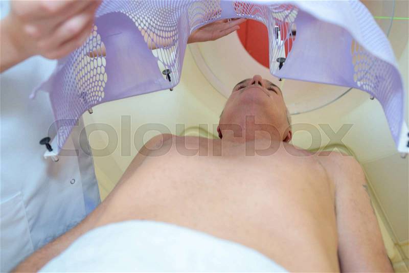 Nurse fitting structure over patient\'s body, stock photo