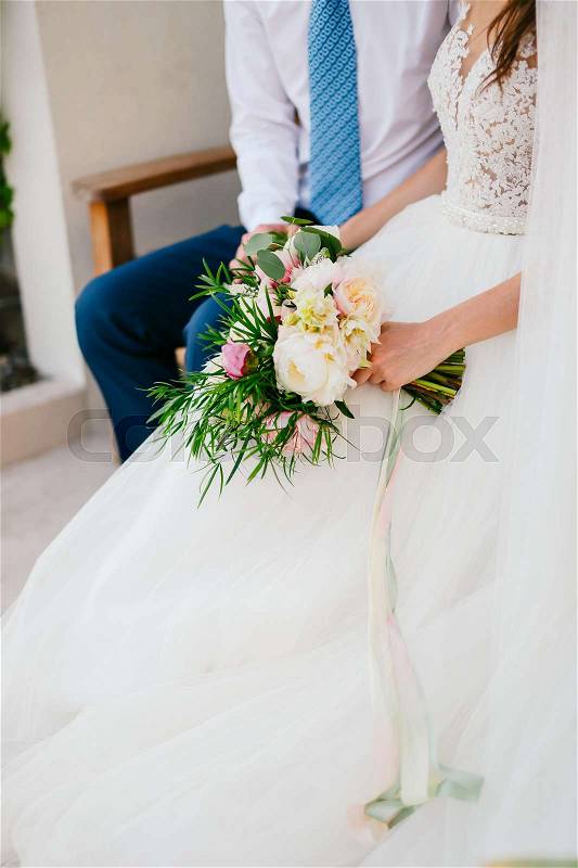 Wedding bouquet of peonies in the hands of the bride. Wedding in Montenegro, stock photo