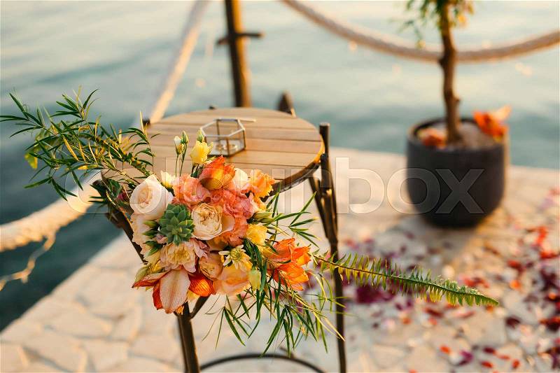 Table for the wedding ceremony, flower arrangement. Wedding decorations. Wedding at the sea in Montenegro, stock photo
