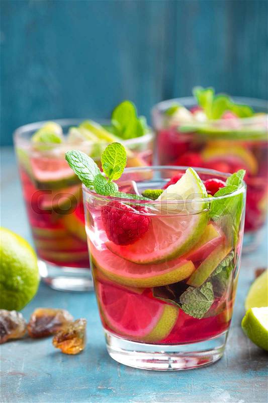 Refreshing mint cocktail mojito with rum, lime and raspberry, cold drink or beverage, stock photo
