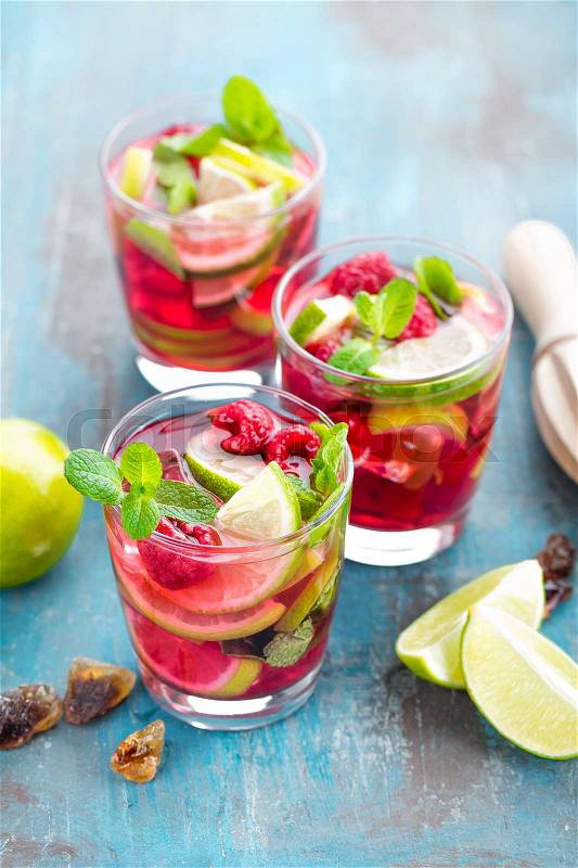 Refreshing mint cocktail mojito with rum, lime and raspberry, cold drink or beverage, stock photo