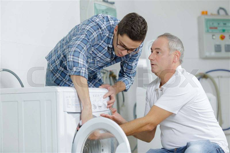 Professional workmen visiting client after-sales service at home, stock photo