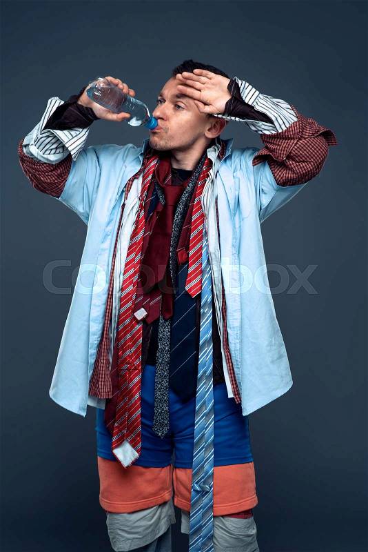 Tired male buyer drink water after clothes sale. Shopping concept. Clothing store advertising, stock photo