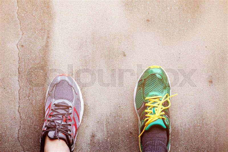 Foot with shoes on the old concrete wall, stock photo