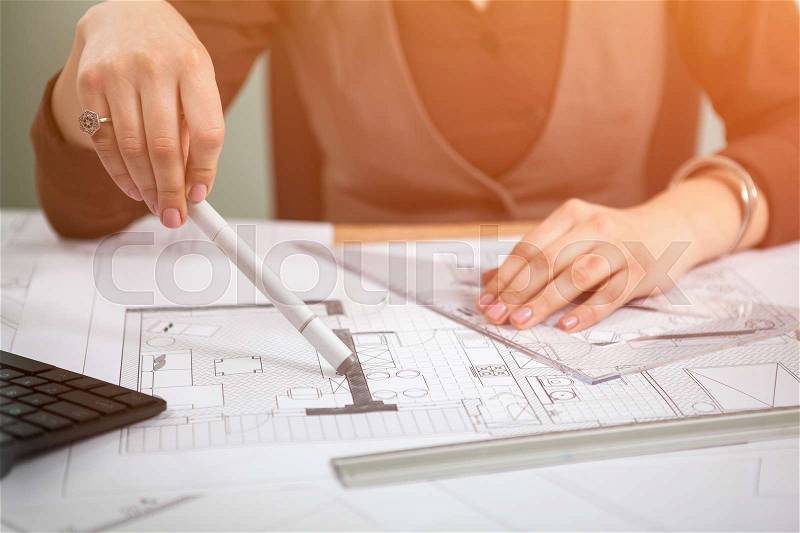 Details shot of architect blueprints on a desk. Business and creativity. Architecture job, stock photo