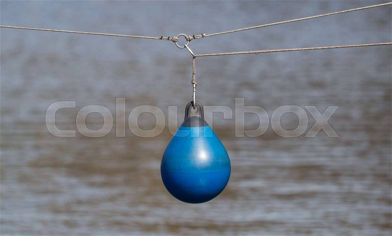 BLue buoy hanging out to dry, selective focus, stock photo