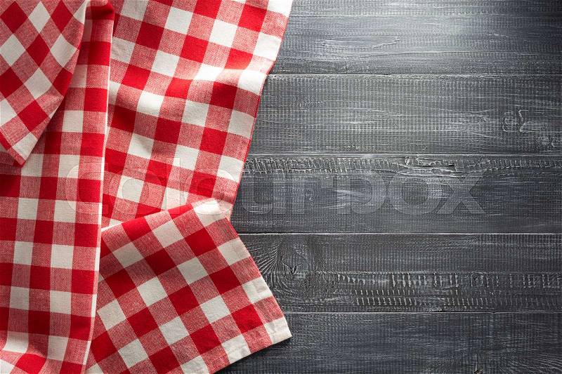 Cloth napkin checked on wooden background, stock photo