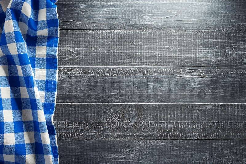 Cloth napkin checked on wooden background, stock photo