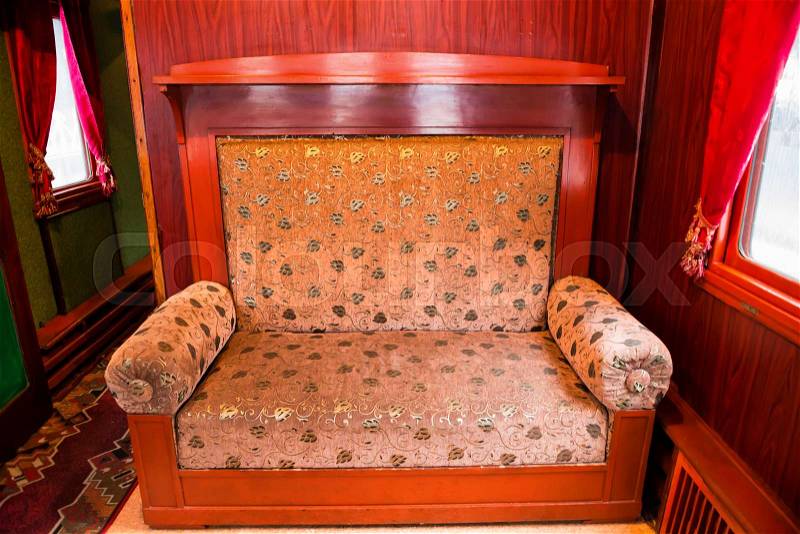 Vintage old sofa in the compartment interior. Old luxury wagon in a train, stock photo