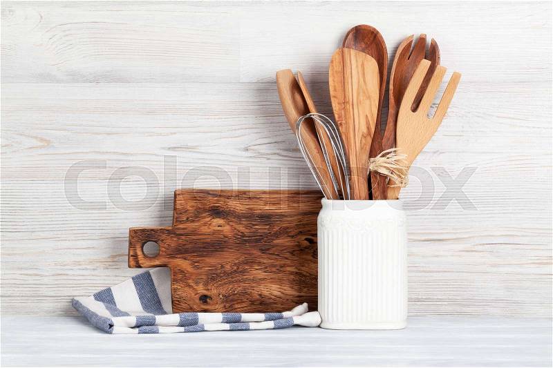 Kitchen utensils in front of wooden wall with space for your text, stock photo