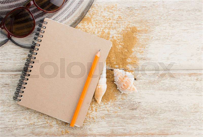 Summer vacation concept,paper blank page with hat and sunglasses on old wooden with space for text, stock photo