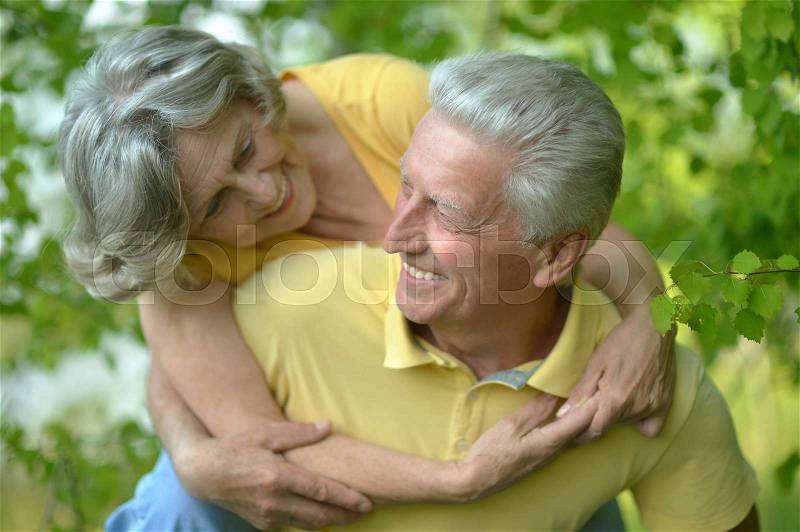 Old happy married couple on a summer walk, stock photo