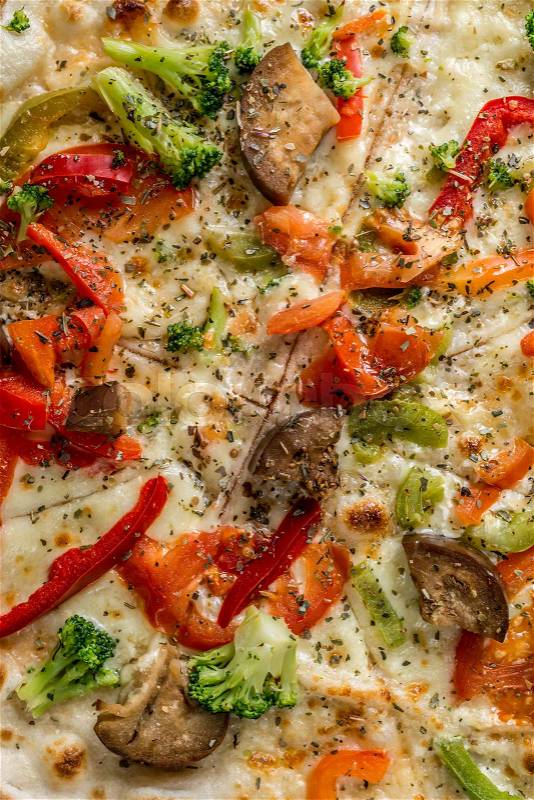 Hot steaming pizza with vegetables and mushrooms, cheese, served and cut, closeup, topview, stock photo