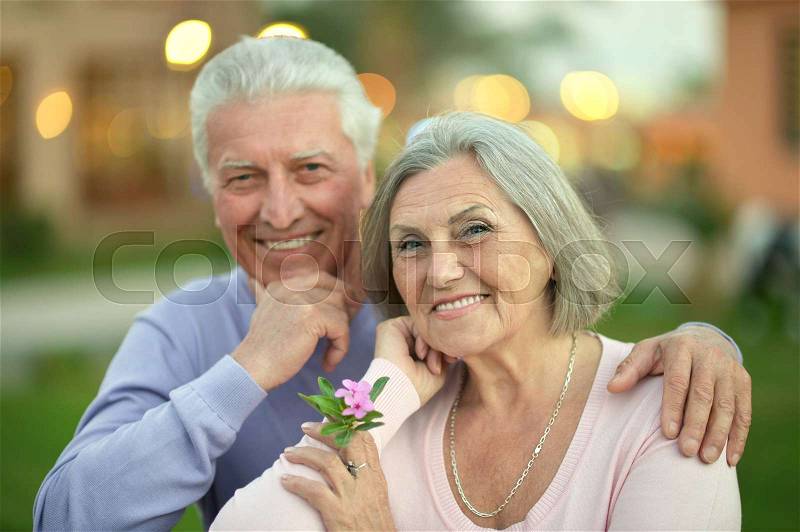 Happy cute elderly couple on a summer walk, stock photo