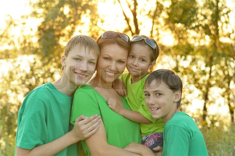 Happy parents with their children spend time outdoors, stock photo