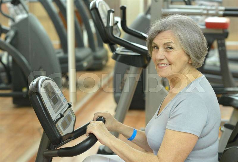 Elderly in sportswear practice sports in the gym, stock photo